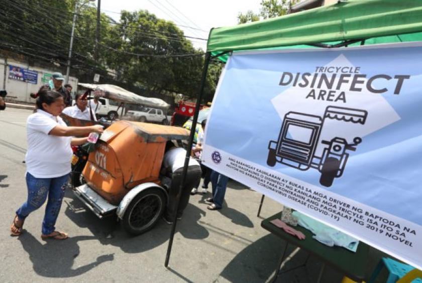 SANITIZING RIDES A “disinfection area” is set up especially for tricycles in Barangay Kaunlaran, Quezon City, on Saturday, hours before the start of the monthlong quarantine covering the entire Metro Manila. —NIÑO JESUS ORBETA  