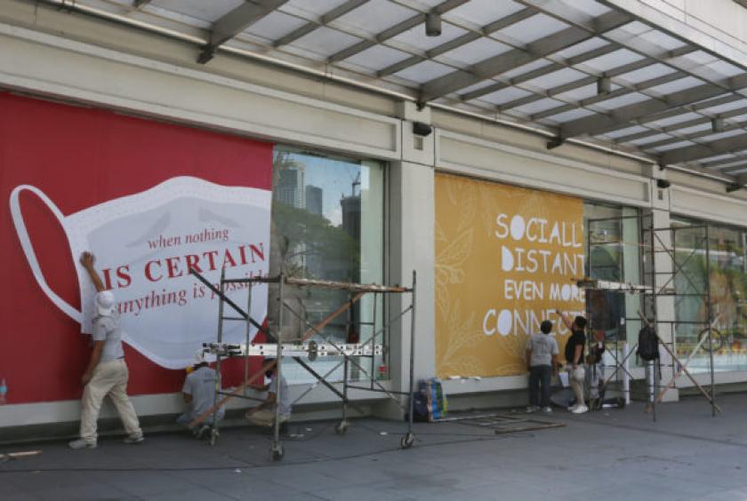 FOR LIMITED SHOPPING Workers spruce up shop windows along Ayala Avenue in Makati City as shopping malls in Metro Manila prepare for partial reopening with the easing of lockdown restrictions beginning this weekend. Retailers expect the government to allow limited shopping as part of a phased exit from quarantine to resuscitate the economy. —MARIANNE BERMUDEZ