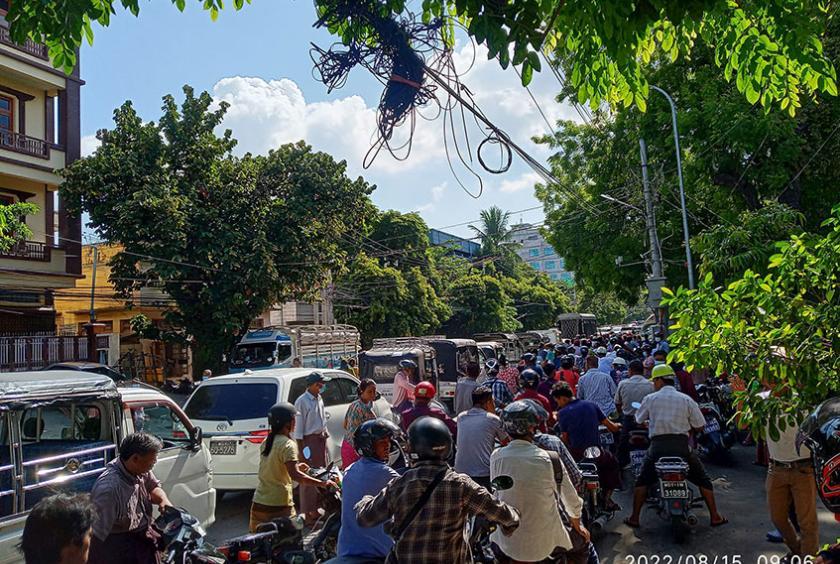 Photo shows motorists and motorcyclists waiting in line to buy fuel in Mandalay (Photo-Thet Tun Aung)