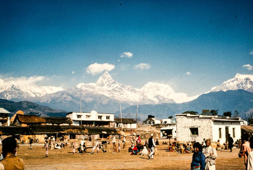 People mingle and wait for the plane to land at the airfield in Pokhara in a photo taken in 1964 or 1965. Nepal Photo History Project/Peace Corp