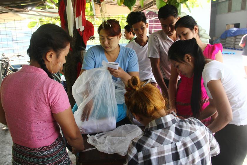 A factory in Hlaingthaya Industrial Zone pays compensations to workers on 11 March. (Photo-Shine Lin Aung) 