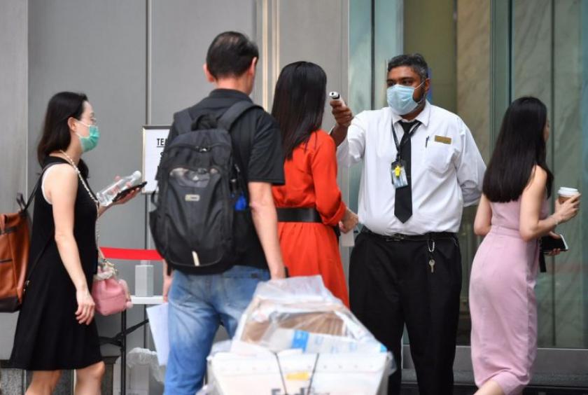 People queuing up to get their temperatures checked at One Raffles Place on Feb 10, 2020.ST PHOTO: CHONG JUN LIANG