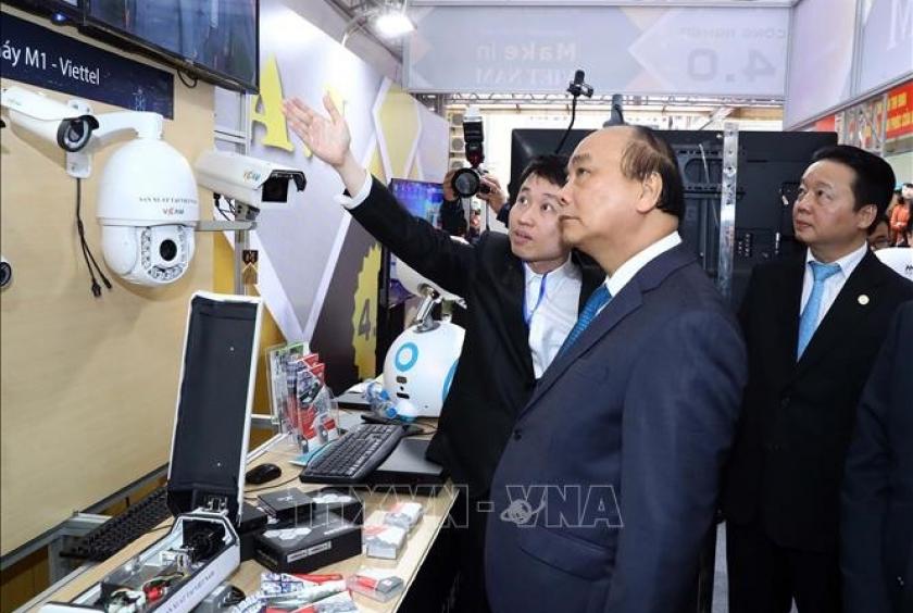 Prime Minister Nguyễn Xuân Phúc views a display of ditigal technologies. He has asked the Ministry of Information and Communications (MIC) to increase Việt Nam’s rankings in information and communication technology (ICT). — VNA/VNS Photo Thống Nhất 