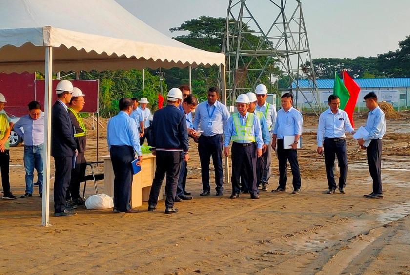 Deputy Minister Khin Maung Win inspects the place of new power plant.