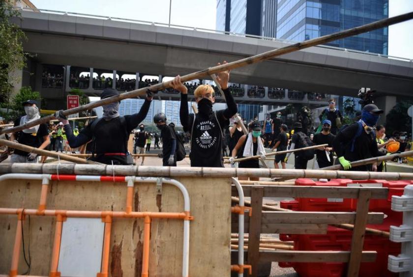 Protesters build barriers as they block a road in Hong Kong's Kwun Tong district on Aug 24. PHOTO: AFP