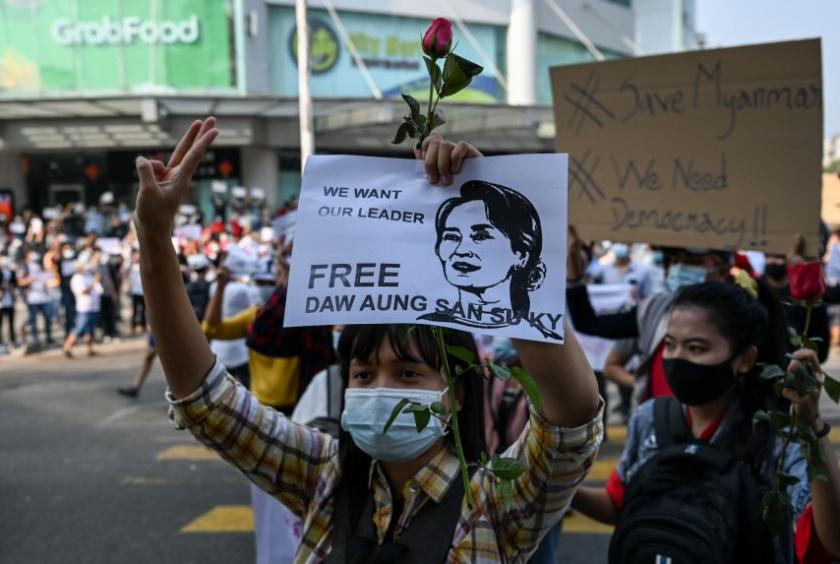 A protester holds up a sign during a demonstration against the military coup in Yangon on Feb 7, 2021.PHOTO: AFP