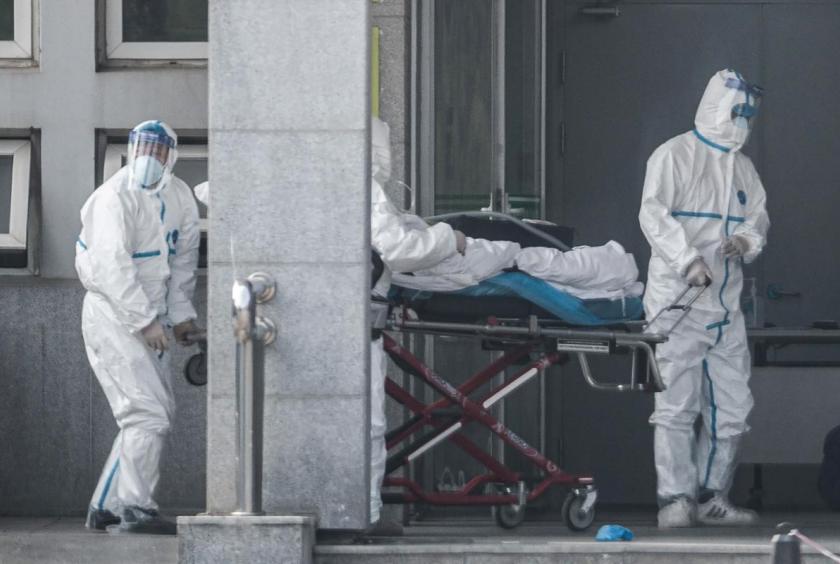 Medical staff members carry a patient into the Jinyintan hospital, where patients infected by Coronavirus are being treated, in Wuhan in China's central Hubei province. (File Photo: AFP)
