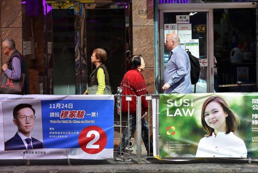 Campaign banners displayed in Hong Kong's Wanchai district. The political unrest of recent months in the city has overshadowed what would normally be a calm campaign. A pro-democracy candidate had his ear bitten off, while 17 other candidates of all stripes have been arrested over protest-related activities. PHOTO: AGENCE FRANCE-PRESSE