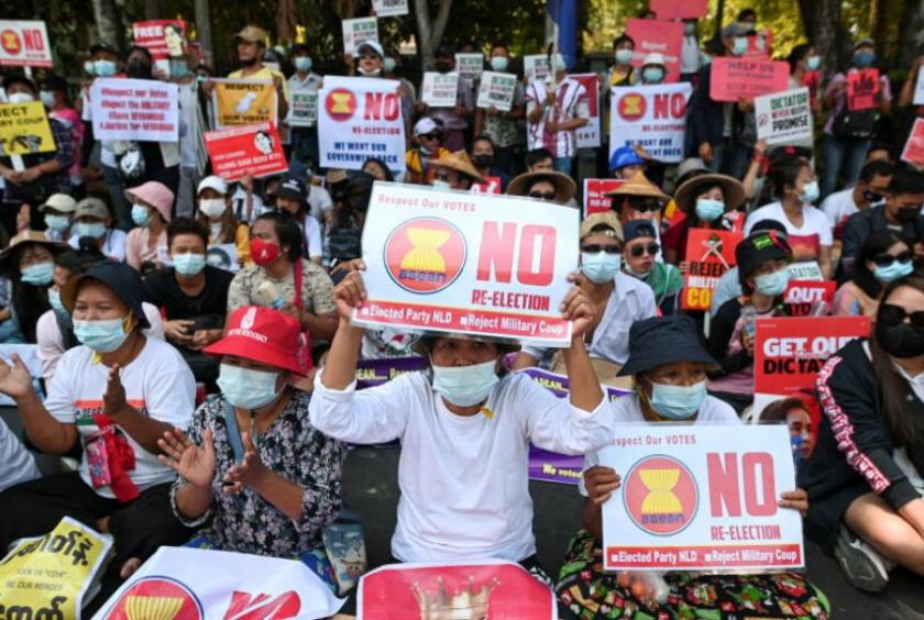Demonstrators hold placards during a rally in front of the Indonesian embassy in Yangon, on Feb 24, 2021.PHOTO: REUTERS