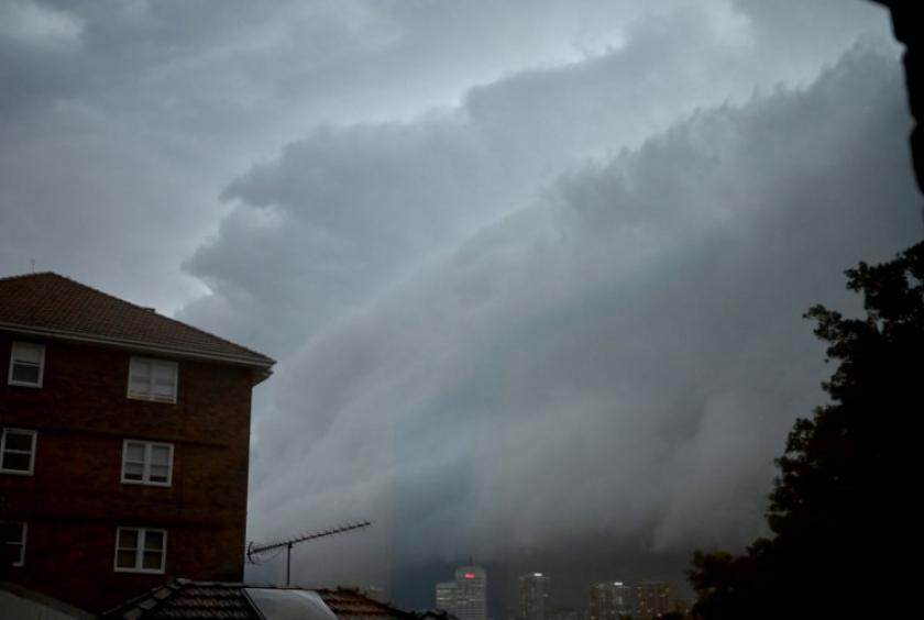 This photo taken through a window on February 8, 2019 shows storm clouds gathering over Bondi Junction in Sydney. Thousands of Sydney homes were without power on February 9 after severe storms hit Australia's largest city, causing transport hold-ups, inundating vehicles with floodwater and delaying a national football match. PETER PARKS / AFP (AFP/Peter Parks)