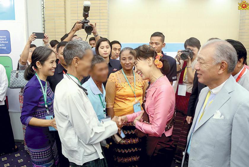 Myanmar State Counsellor shake hands with patients at Leprosy Eradication Conference. (Photo-Myanmar State Counsellor Office) 