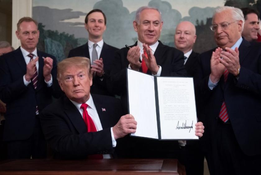 US President Donald Trump holds up a signed Proclamation on the Golan Heights alongside Israeli Prime Minister Benjamin Netanyahu in the Diplomatic Reception Room at the White House in Washington, DC, March 25, 2019. US President Donald Trump on Monday signed a proclamation recognizing Israeli sovereignty over the disputed Golan Heights, a border area seized from Syria in 1967. (AFP/Saul Loeb)
