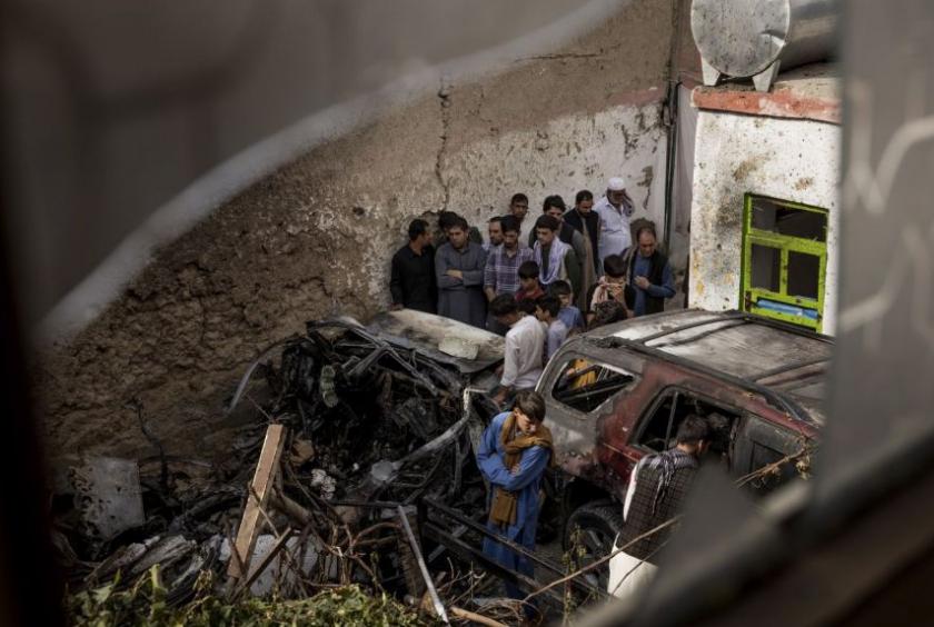 Relatives and neighbours gather near damage from a US drone strike in the courtyard of Zemari Ahmadi's home in Kabul, Afghanistan, on Aug 30, 2021.PHOTO: NYTIMES