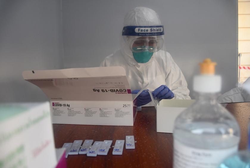 A health staff member prepares Covid-19 tests on domestic air passengers (Photo-Kyin Naing) 