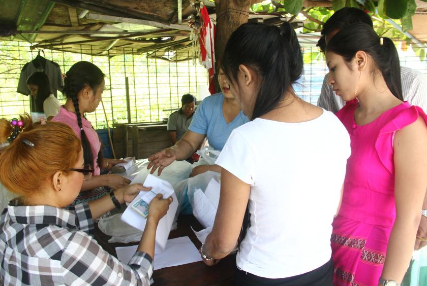 Workers being paid compensation on March 11 after Letwar Garment Factory (3) in Hlinethaya Industrial Zone closed temporarily. (Photo-Shine Lin Aung) 