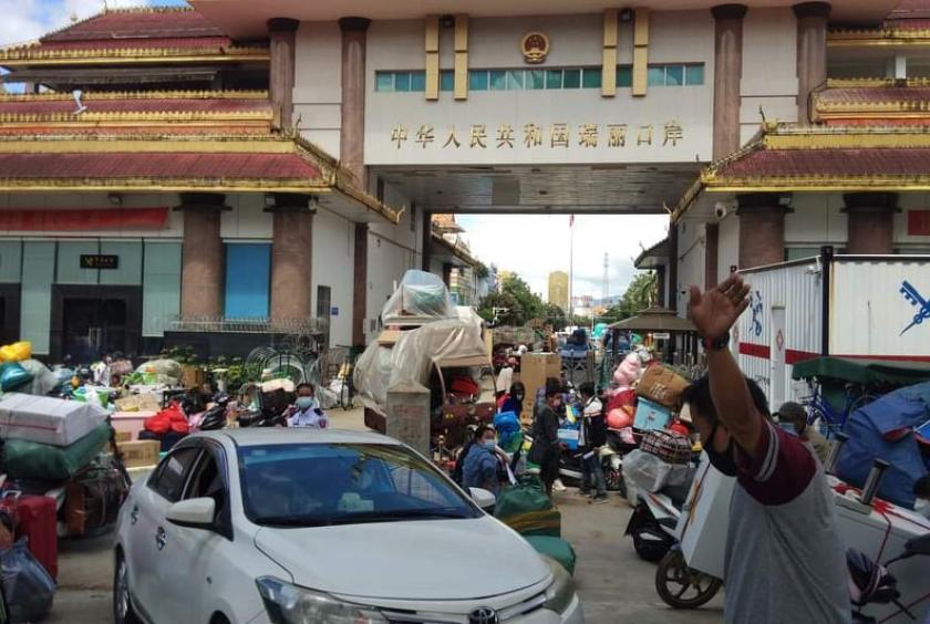 Myanmar migrant workers seen at Nandaw border checkpoint after returning from China 