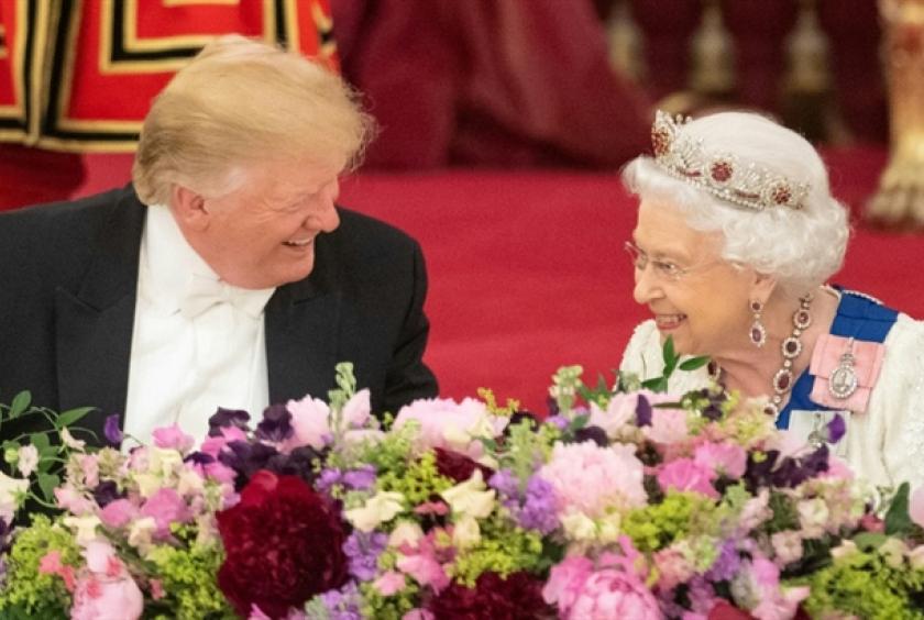 Britain's Queen Elizabeth II laughs with US President Donald Trump during a state banquet at Buckingham Palace. —  AFP Photo  