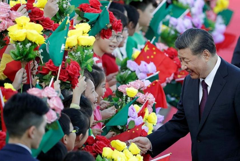Chinese President Xi Jinping greeting children holding Chinese and Macau flags on arrival in Macau yesterday, ahead of the 20th anniversary of the former Portuguese colony's return to China. During his three-day visit, Mr Xi is expected to announce a raft of policies aimed at diversifying the city's gaming-focused economy.PHOTO: REUTERS