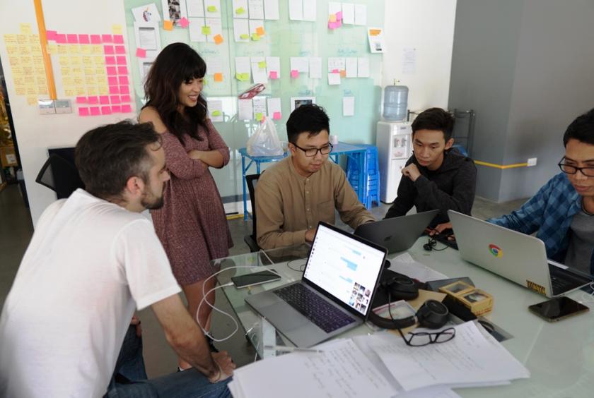 Ye Myat Min, co-founder and CEO of Nexlabs (middle, wearing glasses), works on a new product together with team members