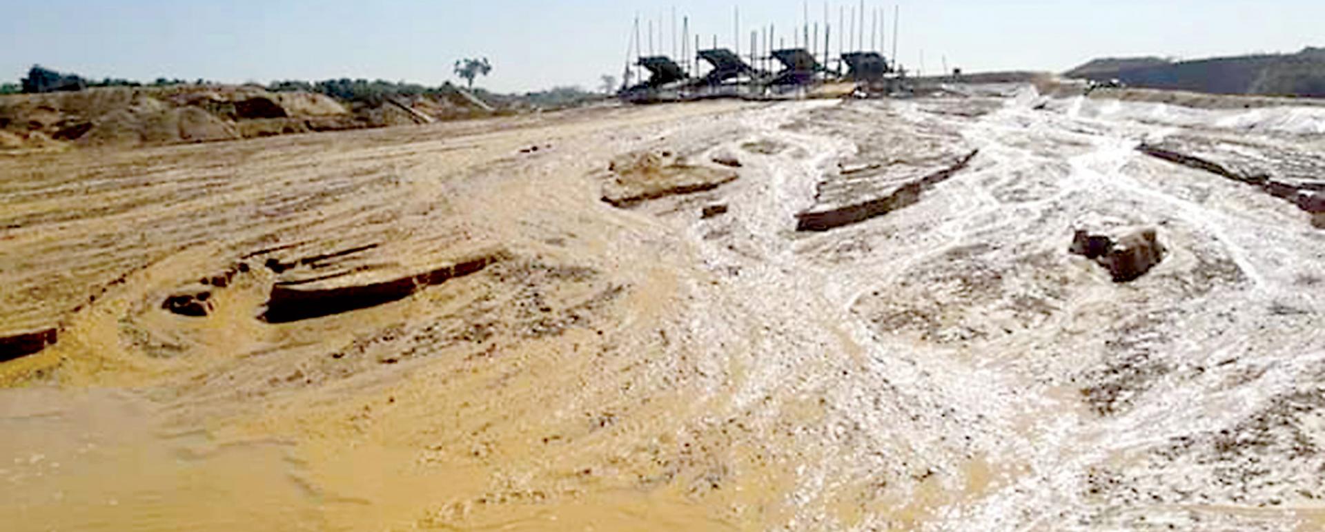 Waste soil produced from gold mines near houses and school in Gyokepin village.