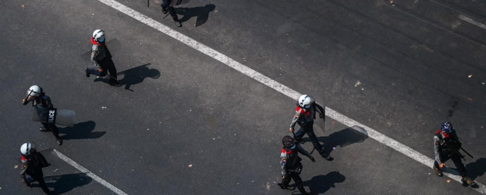 Police walk on a street in Yangon on February 28, 2021, as security forces continue to crackdown on demonstrations by protesters against the military coup. (Agence France Presse/Ye Aung Thu)