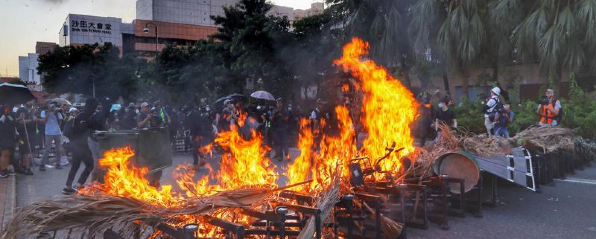 Rioters block roads and set fire to barricades in Sha Tin on Sunday. They also vandalized Sha Tin MTR station, disrupted businesses and damaged facilities at a shopping mall. CHINA DAILY