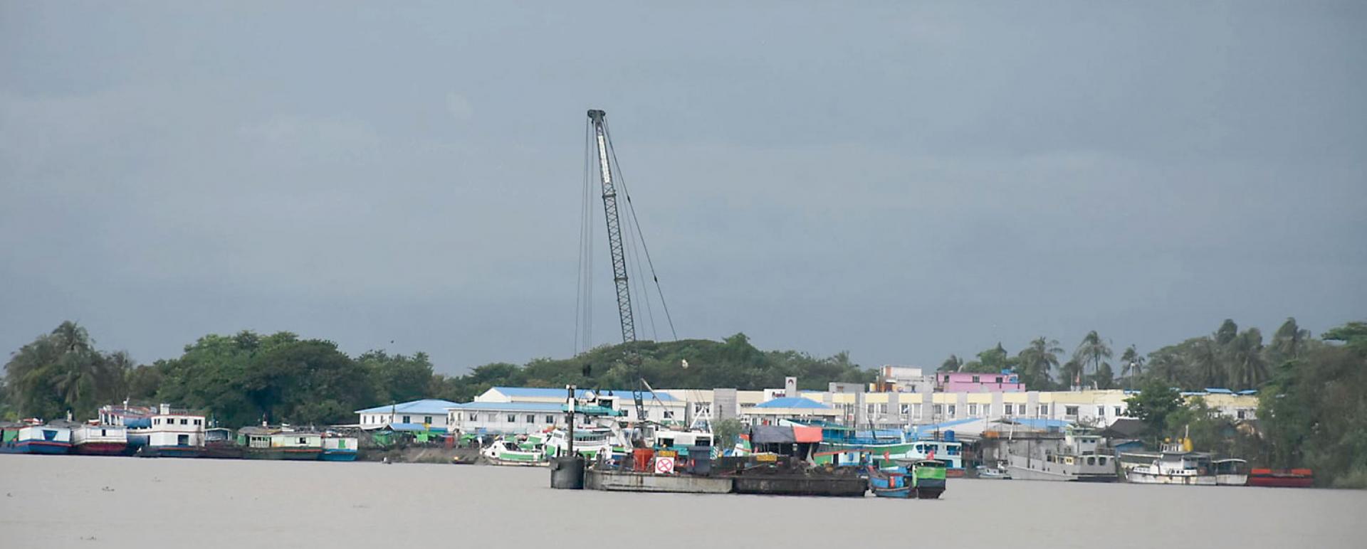 Ferries and cargo ships docked along Ngawun River in Pathein Township, yesterday evening